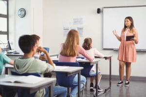 schoolgirl giving presentation in classroom KU3JRLM